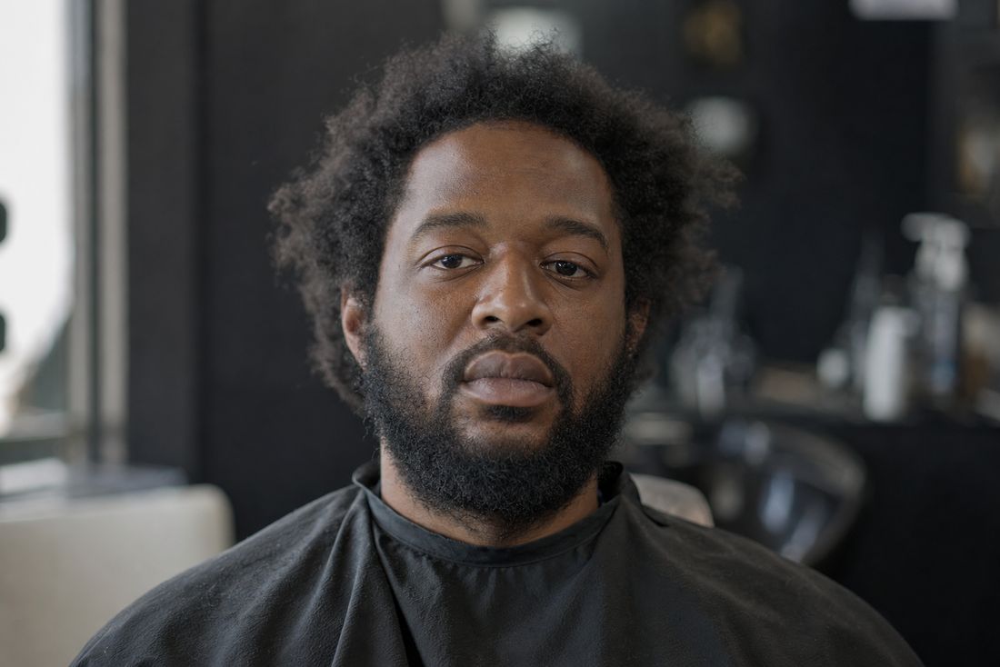 Client before his haircut, uneven sides and an unshaped beard