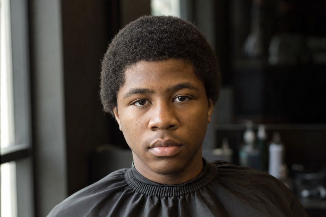 Young client before his haircut, hair grown out flat with no taper
